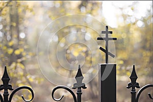 Cross on the cast-iron fence of the church