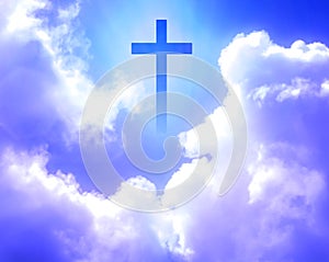 The cross of Christ appeared brightly in the sky with beautiful fluffy white clouds.