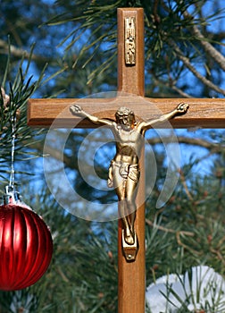 Cross with Christ on it and Christmas tree with red ball