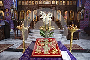 A cross in the church with an iconostasis in the background