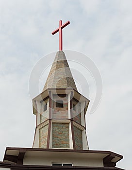 Cross on a church before an overcast sky