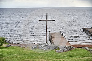 Cross at the church rowing bridge where rowing boats add below the church in RÃÂ¤ttvik Dalarna photo