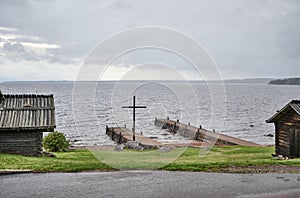 Cross at the church rowing bridge where rowing boats add below RÃÂ¤ttvik church photo