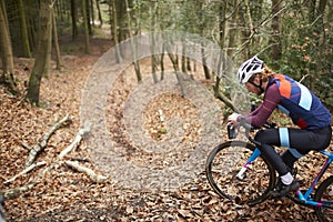 Cross-country cyclist resting on bike with water bottle