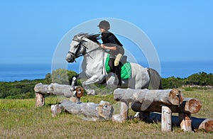 Cross country girl and pony jumping