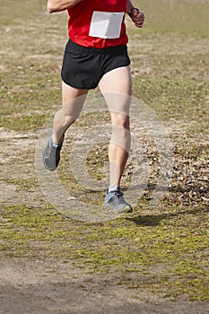 Cross country male runner on a race. Healthy exercise