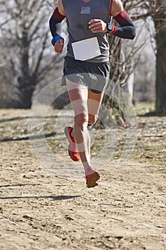 Cross country male runner on a race. Healthy exercise