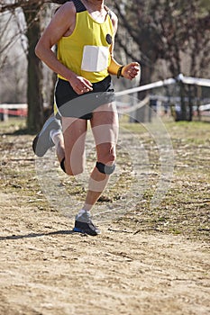Cross country male runner on a race. Healthy exercise