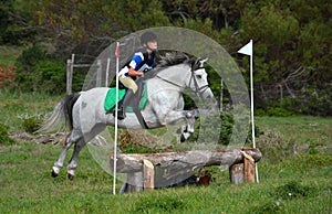 Cross country rider and pony jumping