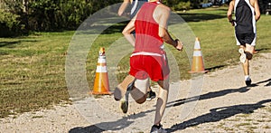 Cross country runner racing on dirt path