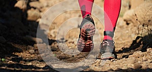 Cross country running feet run through rocky terrain