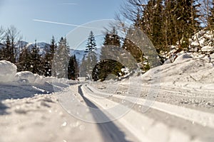 Cross-country skiing in Austria, Hinterthal: Slope, fresh white powder snow and mountains, blurry background