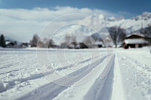 Cross-country skiing in Austria: Slope, fresh white powder snow and mountains, blurry background