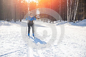 Cross country skiing, happy man skier active winter sport on snowy track, sunset background