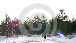 Cross-country skiing on a sunny day. Athletic man skiing in the winter forest.