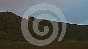 cross-country vehicle on high hill of shore near sea. Yamal peninsula with its wild nature.
