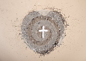 Cross or crucifix in heart shaped ash. Lent Season, Holy Week and Good Friday concept