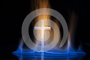 Cross or crucifix surrounded by burning fire flames