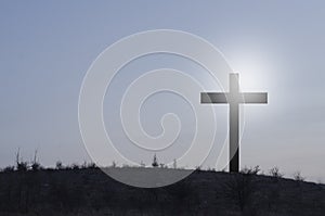 Cross, crucifixion. Against the background of the sky. Cross of Jesus. Religious symbol of Christianity.