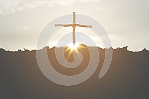 Cross crucifixion of jesus christ on a mountain silhouette with a sunset background. Easter concept day or Good friday.