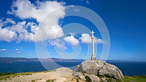Cross in finisterre end of Saint James Way in Spain photo