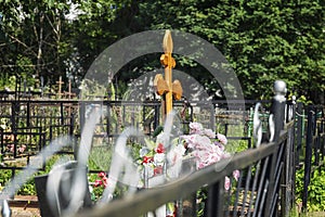 A cross on a fresh grave in a Christian cemetery. Everlasting memory
