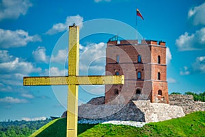 Cross in front of Gediminas castle tower in Vilnius on a sunny summer day, Lithuania