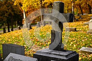 A cross in a graveyard in Autumn