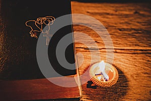 Cross with Holy Bible and candle table