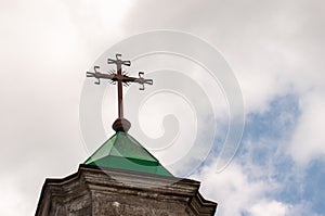 Cross isolated in blue sky background. Church Roof with a cross. Minimal architecture design and detail. Exterior design and