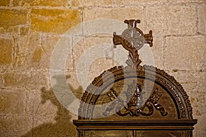 Cross and its shadow indoor of Santillaina del Mar church photo