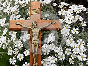 Cross with Jesus Christ on tiny white flowers