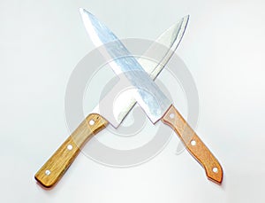 Cross of kitchen knives on a white background. Kitchen knives are crossed with blades. Kitchen fighting and rivalry. Butcher knive