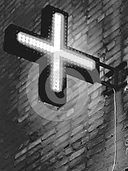 a cross from an LEDin the dark and an electric wd, an advertisement design for a pharmacy on a building