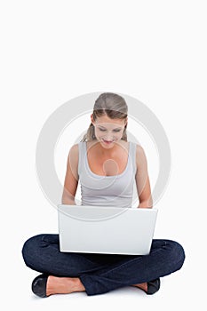 Cross-legged woman using a laptop