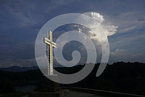 Cross with lights under a dramatic sky