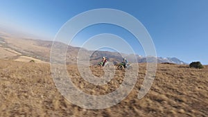 Cross motorbike downhill sport man extreme racing desert crag summit sky sun aerial view
