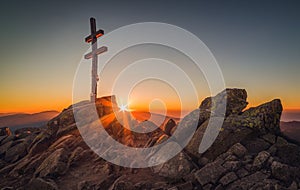 Cross on Mountain Peek at Sunset