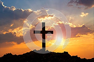 Cross on mountain sunset background. Easter concept.