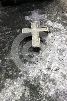 A cross in a old grave in Paris