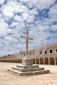 Cross and old monastery
