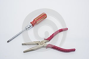 Cross and pliers against white background