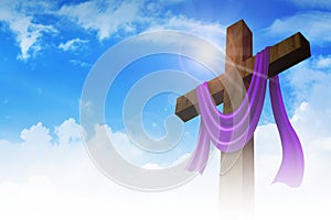 A cross with purple sash on clouds background photo