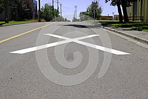 Cross at a railway crossing to warn and slow down traffic