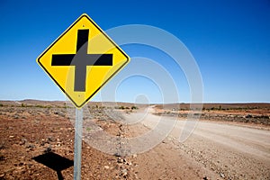 A cross road sign in the desert of South Australia.