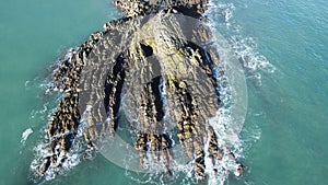 cross, rocks and sea behind the sky