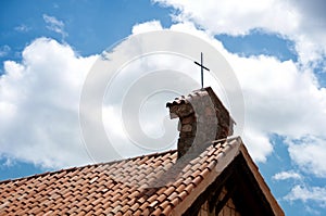 Cross on the roof of a church in the village of Altos de Chavon