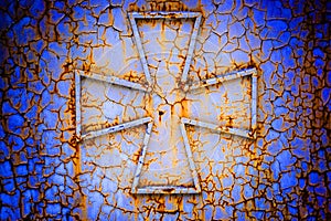 Cross on a rust metall