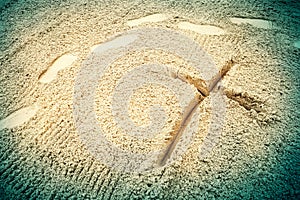 Cross in sand photo