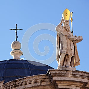 A cross and sclupture on the Church of St. Blasius photo